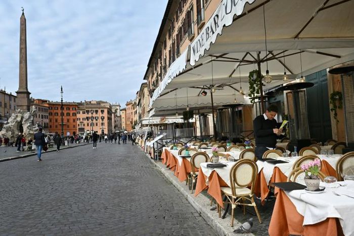 Many of Rome's outdoor restaurants and cafes were either closed Friday night or had free tables overseen by forlorn staff with little to do but chat