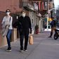Two people wearing protective masks walk in New York city's Upper East Side neighborhood as the coronavirus continues to spread