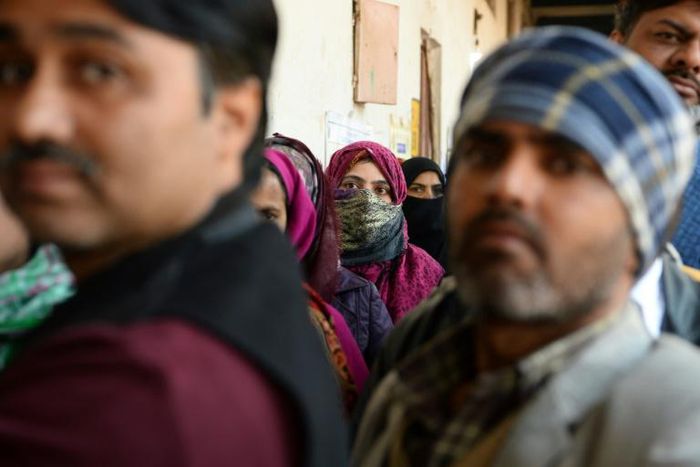 Voters queue to cast their ballots in Delhi's local elections on Saturday