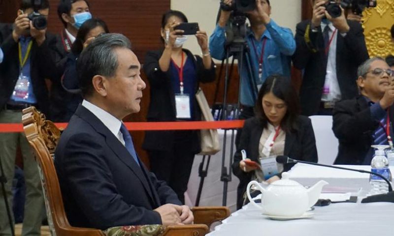 Chinese Foreign Minister Wang Yi (L) says his country's efforts to control the coronavirus outbreak are working