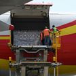 Workers unload supplies from an aircraft at Simon Bolivar International Airport outside Caracas in May 2019