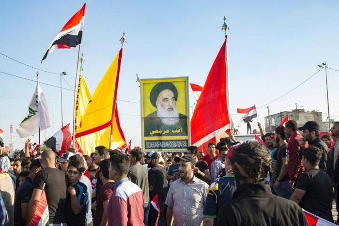 Demonstrators in Iraq's main southern city of Basra hold aloft a portrait of Shiite spiritual leader Grand Ayatollah Ali Sistani, who has increasingly backed their cause