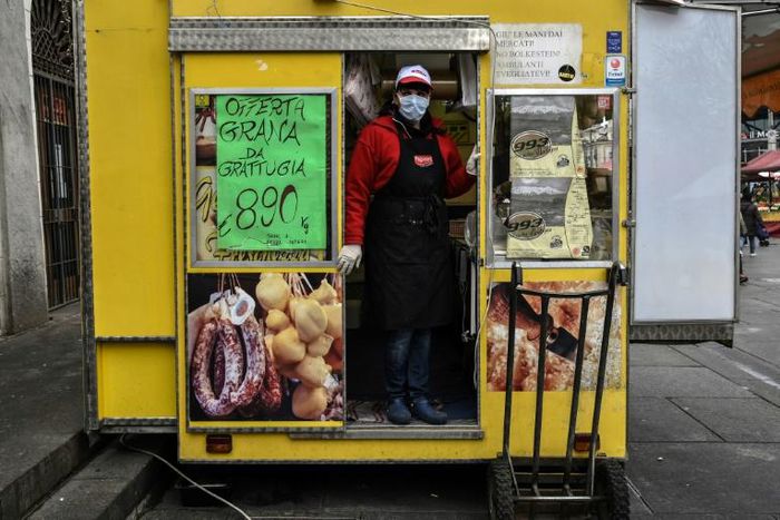Italians rely on delicacy stores like Gina's at the Porta Palazzo food market in Turin for comfort through the coronavirus emergency