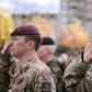 British soldiers serving in a NATO-led international peacekeeping mission in Kosovo salute as they take part in a ceremony in Pristina