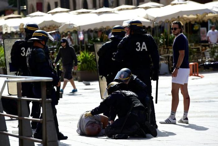 Police attend to injured England fan Andrew Bache following clashes with Russian fans in Marseille ahead of the Euro 2016 football match between England and Russia