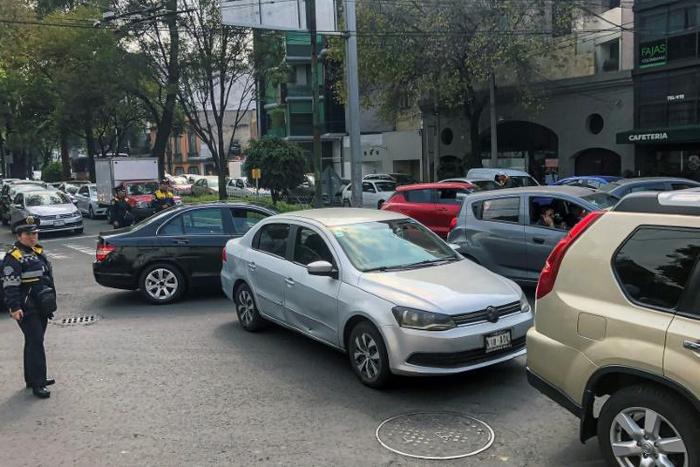 A traffic officer watches over a busy road in Mexico City on November 20, 2019