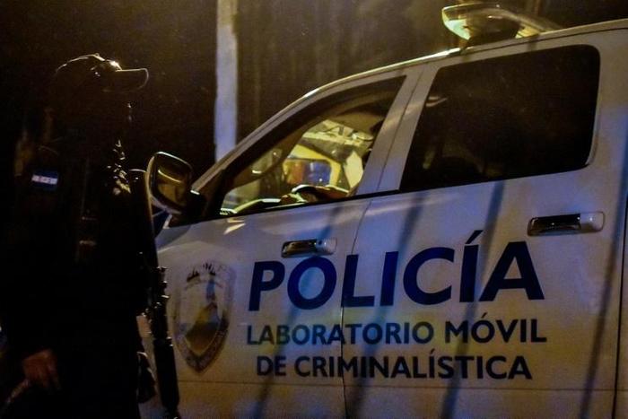 Forensic police arrive at the Tela prison in Honduras on December 21, 2019; officials said overnight fighting between rival gangs had claimed at least 18 lives