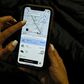 A woman checks the Uber transport application on her mobile phone after authorities ordered its suspension in Colombia, in Bogota on December 20, 2019
