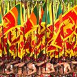 Sri Lankan military personnel in traditional dress holding national flags during Sri Lanka's 72nd Independence Day celebrations in Colombo