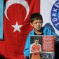 A supporter of China's Muslim Uighur minority holds a placard of Arsenal's Turkish-origin German midfielder Mesut Ozil during a demonstration at Beyazid square in Istanbul