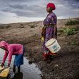 Martha Kasafi and her daughter, refugees from Democratic Republic of Congo, collect water for their crops in Kalobeyei settlement for refugees in  Kenya on October 2, 2019; Independent experts on the Human Rights Committee issued a non-binding ruling i...