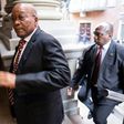 Former South African President Jacob Zuma (C) is alleged to have taken bribes tied to a $3.4 billion arms deal