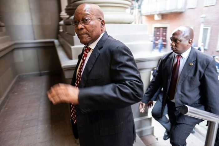Former South African President Jacob Zuma (C) is alleged to have taken bribes tied to a $3.4 billion arms deal