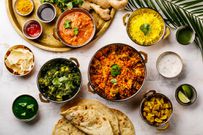 Indian food Curry butter chicken, Palak Paneer, Chiken Tikka, Biryani, Papad, Dal, Rice with Saffron and Naan bread on white background