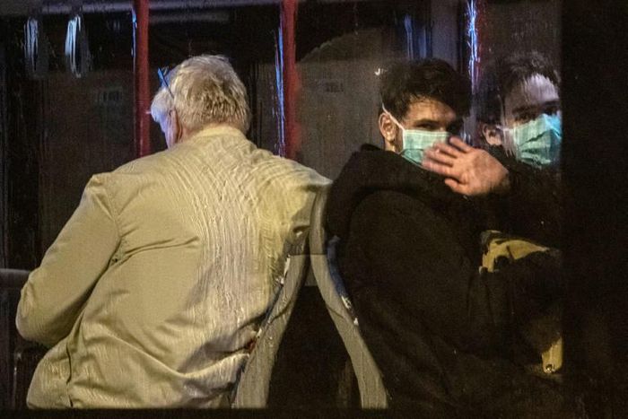 German nationals evacuated Wuhan wait on a bus to be taken to quarantine after arriving at Frankfurt airport