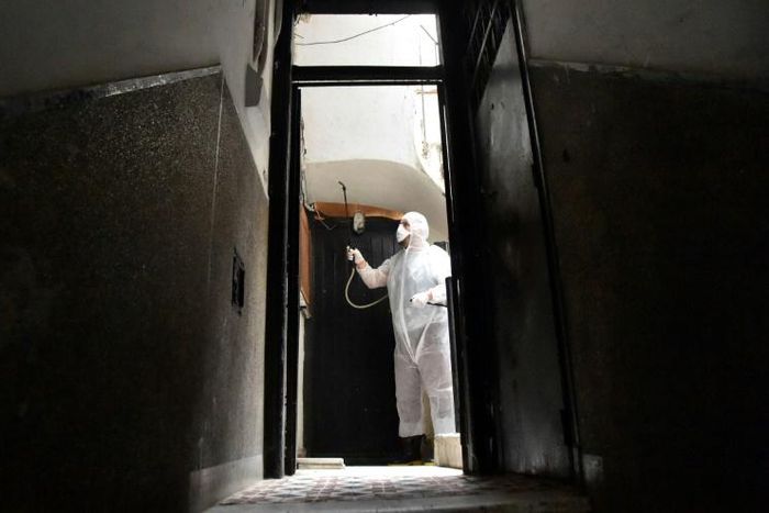 A man disinfects a building in Algiers on March 20