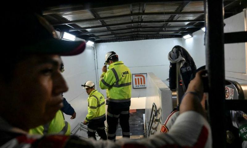 Subway staff enter Tacubaya station in Mexico City after two trains collided