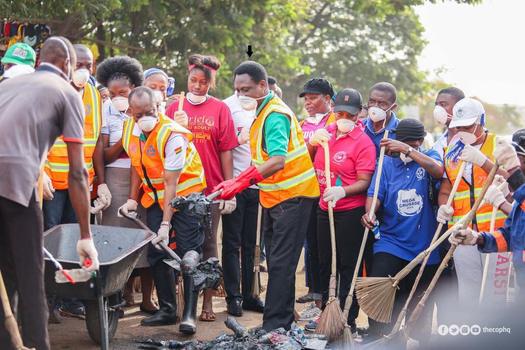 Apostle Eric Nyamekye (arrowed) at the Madina Market cleaning the place