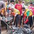 Apostle Eric Nyamekye (arrowed) joining the members to clean the Madina Market