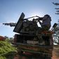 A fighter fires a truck-mounted gun towards Syrian government positions in Saraqeb as the rebels prepare to move on the key northwestern crossroads town