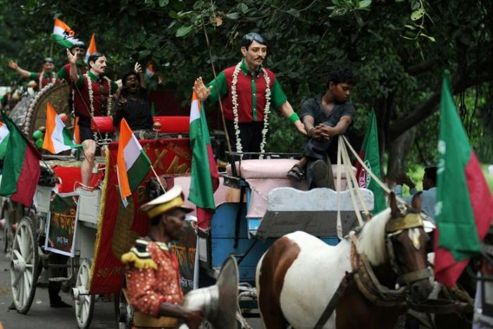 Carts with statues of former Mohun Bagan players are driven through the streets of Kolkata during celebrations marking the club's history in 2011