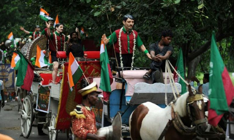 Carts with statues of former Mohun Bagan players are driven through the streets of Kolkata during celebrations marking the club's history in 2011