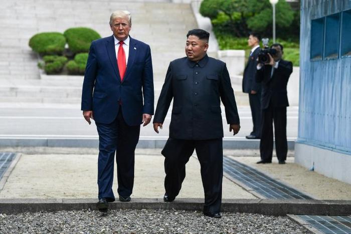 North Korea's leader Kim Jong Un and US President Donald Trump cross south of the Military Demarcation Line that divides North and South Korea, after Trump briefly stepped over to the northern side in June 30, 2019