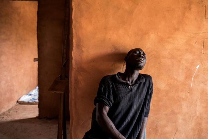 Blues: A young homeless man sings in a quarantined area at a refuge for newly-arrived street children outside Dakar