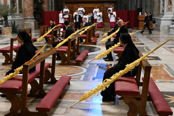 Palm fronds adorned largely empty pews as Pope Francis celebrated Palm Sunday mass in St. Peter's Basilica mass on April 5. Easter services are set to take place behind closed doors