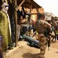 Far from home: A member of France's Barkhane force patrols the market in Menaka, northeastern Mali