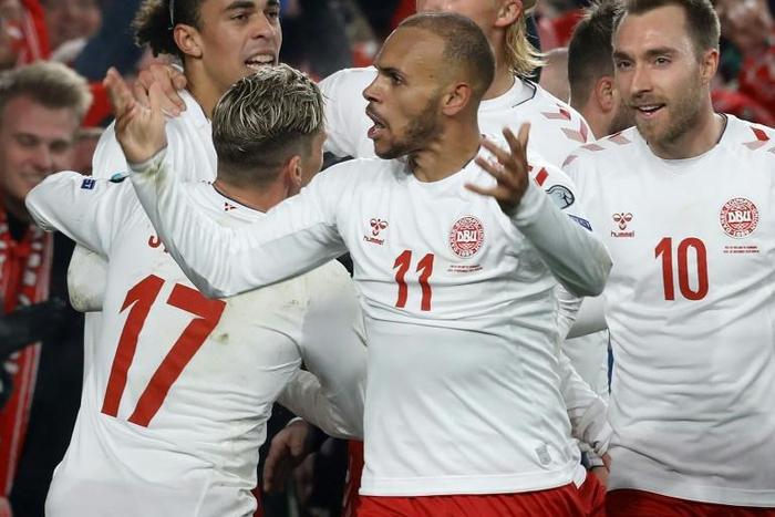 Danish delight: Martin Braithwaite (centre) celebrates the goal which secured Denmark qualification for Euro 2020