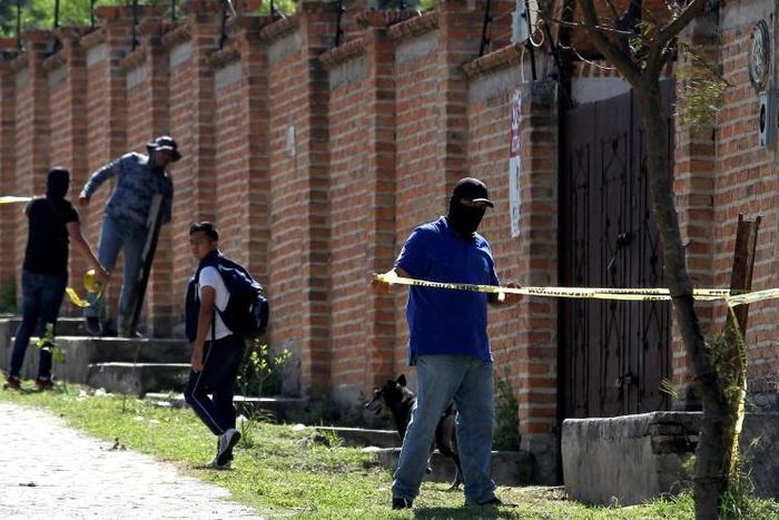 Authorities at work in  the El Mirador neighborhood of Tlajomulco de Zuniga in Jalisco, Mexico, where the remains of at least 50 people were found in a mass grave