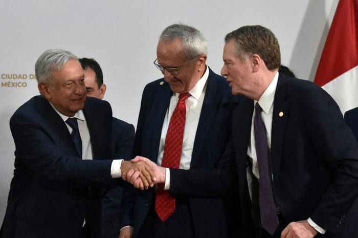 Mexican President Andres Manuel Lopez Obrador (L) shakes hands with US Trade Representative Robert Lighthizer as Mexico's Jesus Seade looks on at the trade pact signing on December 10, 2019 in Mexico City; labor monitoring later became an issue