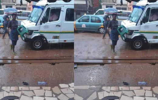 Umbrella seller refuses to use one of her umbrellas to protect herself against rain