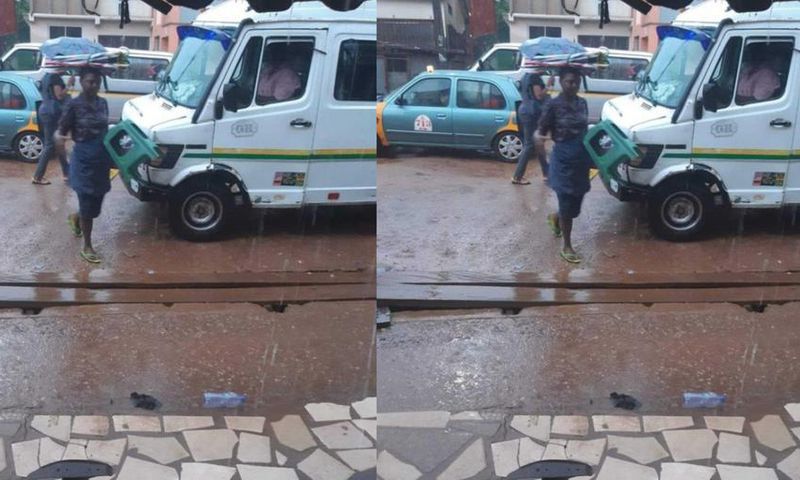 Umbrella seller refuses to use one of her umbrellas to protect herself against rain
