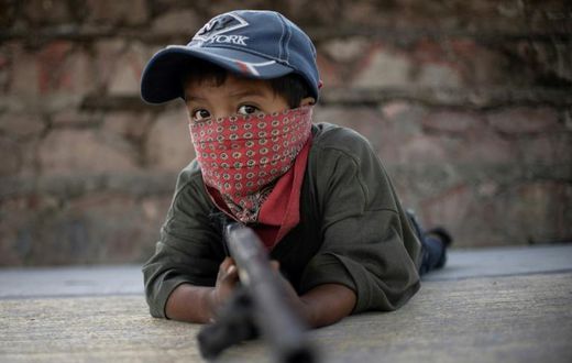 Children in Ayahualtempa train with rifles or makeshift guns to join the fight against drug cartels