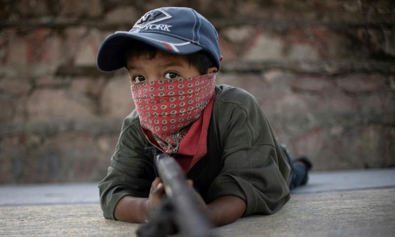 Children in Ayahualtempa train with rifles or makeshift guns to join the fight against drug cartels