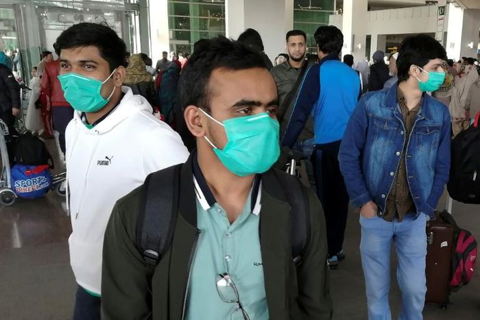 Pakistani students wearing protective face masks arriving in Islamabad from China