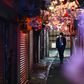 A man wearing a face mask walks along Omoide Yokocho in Tokyo