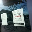 A "closed" sign is viewed on the door of the Tenley/Friendship DC Public Library on March 16, 2020, in Washington, DC