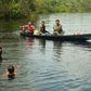 Fishermen and children are seen in the river in Bauana, a village in the heart of the Brazilian Amazon, on March 14
