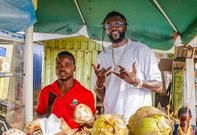 Emmanuel Adebayor spent time with a coconut seller and his wife