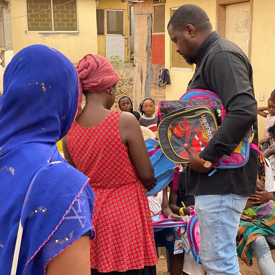 John Dumelo donates hundreds of school bags, exercise books to kids