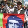A supporter of Bolivian ex-President Evo Morales holds banner with an image of revolutionary leader Ernesto 'Che' Guevara during a demonstration Monday in La Paz