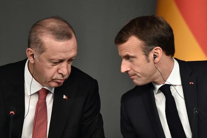 French President Emmanuel Macron, right, has been called accused of "sponsoring terrorism" by the foreign minister of Turkish leader Recep Tayyip Erdogan