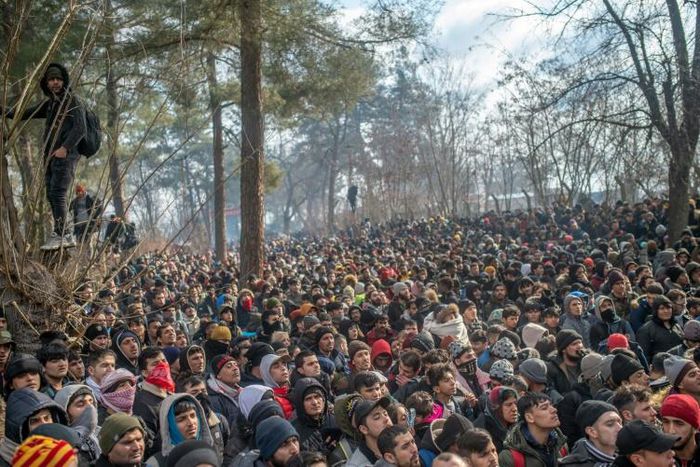 Some of the thousands of migrants gathered at the Turkish side of the border