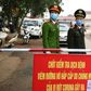 Vietnamese police stand guard at a checkpoint set up at the Son Loi commune in Vinh Phuc province amid concerns about a COVID-19 coronavirus outbreak