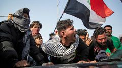 Angry Iraqi demonstrators mourn the killing of female activist and paramedic Janat Madhi, in Basra on Tuesday night, part of an upsurge of violence against the three-month-old protest movement