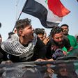 Angry Iraqi demonstrators mourn the killing of female activist and paramedic Janat Madhi, in Basra on Tuesday night, part of an upsurge of violence against the three-month-old protest movement