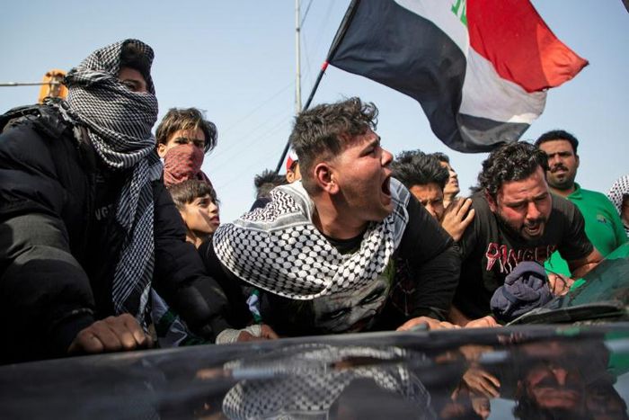Angry Iraqi demonstrators mourn the killing of female activist and paramedic Janat Madhi, in Basra on Tuesday night, part of an upsurge of violence against the three-month-old protest movement